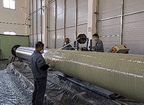 Glass reinforced polymer winding over insulated pipe for mechanical protection